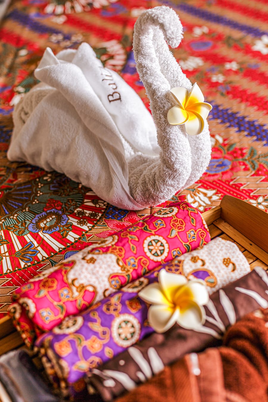 Towel swan and frangipani on a BaliAyu treatment bed